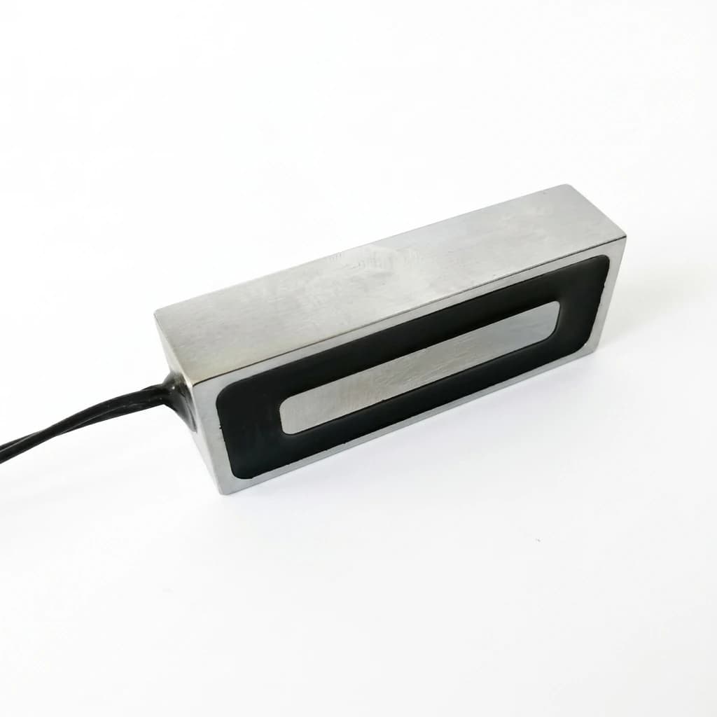 Electromagnetic gripper face with central pole piece and clean DC power leads
